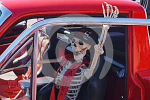 Skeleton driver in cool car invites Halloween riders